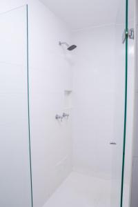 a shower with a glass door in a bathroom at Hotel Edmar in Santa Marta