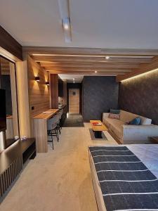 a living room with a couch and a table at Woodside Kopaonik & SPA by Slopeview in Kopaonik