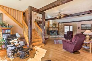a living room with a wooden staircase and chairs at South Dakota Vacation Rental Near Mount Rushmore in Hermosa