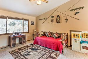 a bedroom with a bed with a red blanket at South Dakota Vacation Rental Near Mount Rushmore in Hermosa