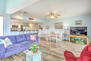 a living room with a purple couch and a table at Beachside St Augustine Vacation Rental Condo! in Coquina Gables