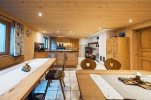 a kitchen with wooden cabinets and a table and chairs at Ferienhaus Bergfrieden in Partenen