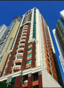 a tall red and white building in a city at Rare 1BR condo, Makati Philippines in Manila
