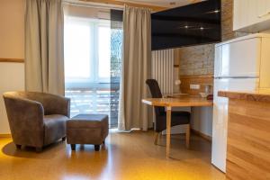 a kitchen with a table and a chair and a desk at Apartmenthaus Erlenbach in Erlenbach