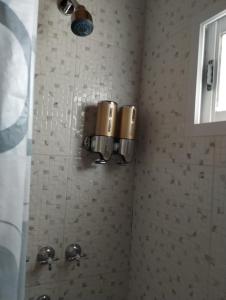 a bathroom with a sink and a light on a wall at Lu-Mar in Comodoro Rivadavia +17 photos