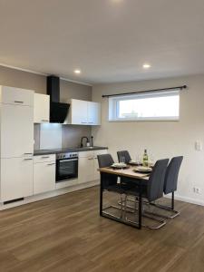 a kitchen with a table and chairs in a room at Moderne Ferienwohnung mit Balkon in Herxheim