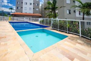 a large blue swimming pool next to a building at Recanto Salgando a Alma in Ubatuba