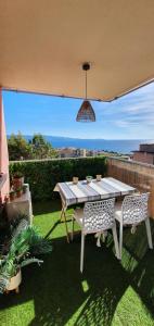a table and two chairs sitting on a patio at Appartement Ajaccio vue mer panoramique in Ajaccio