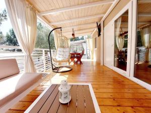 a screened in porch with a couch and a chair at Mina Summerhouse in Jezera