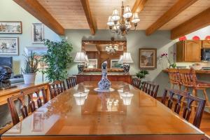 a dining room with a large wooden table and chairs at Townhouse Art Gallery in Mammoth's Best Location in Mammoth Lakes