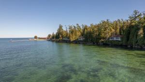 a large body of water with trees and houses at Gordon Lodge in Baileys Harbor