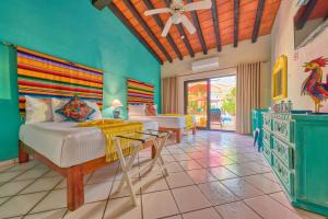a bedroom with a bed and a table in a room at Casa Maria Hotel Boutique & Gallery Adults Only in Puerto Vallarta