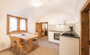 a kitchen with a table and chairs in a room at Chesa Treig in Samedan