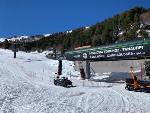 a ski lift with a snowmobile in the snow at Rusina in Santa Venerina