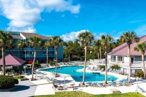 an aerial view of a resort pool with palm trees at The Southern Harmony in Folly Beach