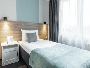 Postel nebo postele na pokoji v ubytování PARK HOTEL VILNIUS