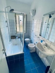 a bathroom with a tub and a sink and a toilet at Bella Tao in Taormina