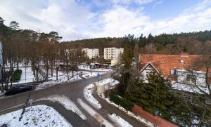 a city street with snow on the ground and buildings at ApartamentyGdansk eu Mieszkanie Przylesie in Sopot
