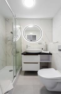 a bathroom with a toilet and a sink and a mirror at ApartamentyGdansk eu Mieszkanie Przylesie in Sopot