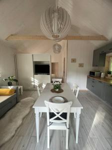 a white table and chairs in a living room at Luxury countryside house 2 min walk to the beach in Narva-Jõesuu
