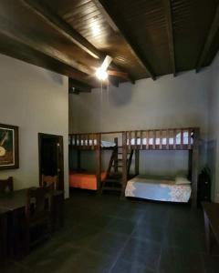 a room with two bunk beds and a table at Bama House hn in Valle de Ángeles