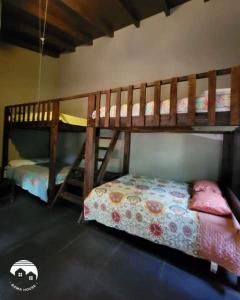 a bedroom with two bunk beds and a bed at Bama House hn in Valle de Ángeles