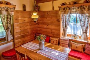 Chalupa pod lipou في أوسكادنيكا: غرفة طعام مع طاولة ونوفذين