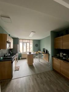 a kitchen with wooden cabinets and a table in it at APPARTEMENT KENNEDY in Boulogne-sur-Mer