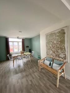 a living room with a couch and a table at APPARTEMENT KENNEDY in Boulogne-sur-Mer