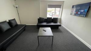 a living room with a couch and a coffee table at Hosted By Ryan - 1 Bedroom Apartment in Liverpool