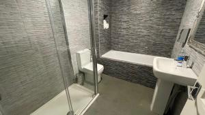 a bathroom with a shower and a toilet and a sink at Hosted By Ryan - 1 Bedroom Apartment in Liverpool