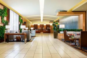 a lobby of a hotel with chairs and tables at The Westin Arlington in Arlington