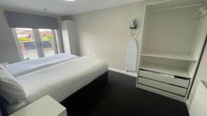 a bedroom with a bed and a large window at Hosted By Ryan - 1 Bedroom Apartment in Liverpool