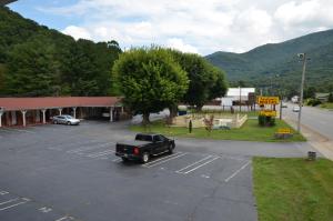 a truck parked in a parking lot in front of a building at Travelowes Motel - Maggie Valley in Maggie Valley