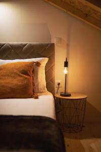 um quarto com uma cama e um candeeiro sobre uma mesa em Retiros do Vale em Vila Real