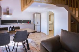 a kitchen and a living room with a table and chairs at Retiros do Vale in Vila Real