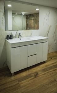 a bathroom with a white sink and a mirror at Retiros do Vale in Vila Real