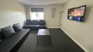 a living room with a couch and a coffee table at Hosted By Ryan - 2 Bedroom Apartment in Liverpool