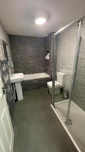 a bathroom with a toilet and a sink and a shower at Hosted By Ryan - 2 Bedroom Apartment in Liverpool