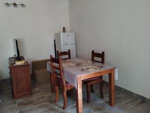 un tavolo da pranzo con sedie e un frigorifero di LuMar3 a Comodoro Rivadavia Altre 9 foto