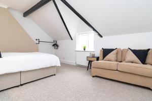 a bedroom with a bed and a couch at south view in Bournemouth