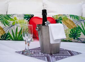 a bucket with a bottle of wine and a glass at Casita Piedra Escrita- Private house in Córdoba