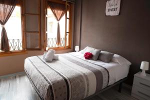 a bedroom with a bed with a red stuffed animal on it at Casita Piedra Escrita- Private house in Córdoba