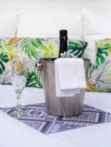 a bottle of champagne in a bucket next to a glass at Casita Piedra Escrita - Private & Exclusive House in Córdoba