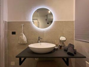 a bathroom with a sink and a mirror at Giano Host - Capro in Genova