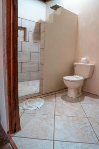 a bathroom with a toilet and a shower at La Tigra Rainforest Lodge in Fortuna