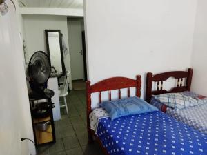 a bedroom with a bed and a mirror at ANNANDA in Florianópolis