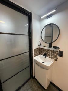 a bathroom with a sink and a mirror at Cichy Apartament Gdańsk in Gdańsk