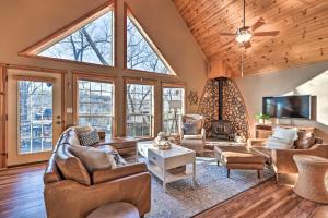 a large living room with a vaulted ceiling with large windows at Pet-Friendly Grand Lake House with Dock and Kayaks! in Eucha
