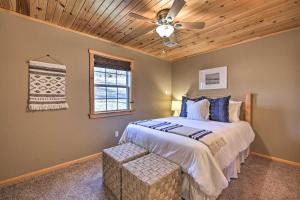 a bedroom with a bed and a ceiling fan at Pet-Friendly Grand Lake House with Dock and Kayaks! in Eucha